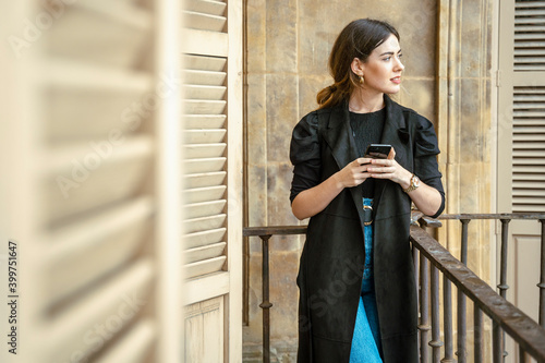 Girl watching a phone on balcony