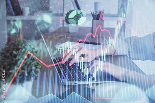 Double exposure of woman hands typing on computer and forex chart hologram drawing. Stock market invest concept.