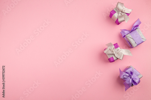 top view little presents on pink background color new year christmas photo gift family free space