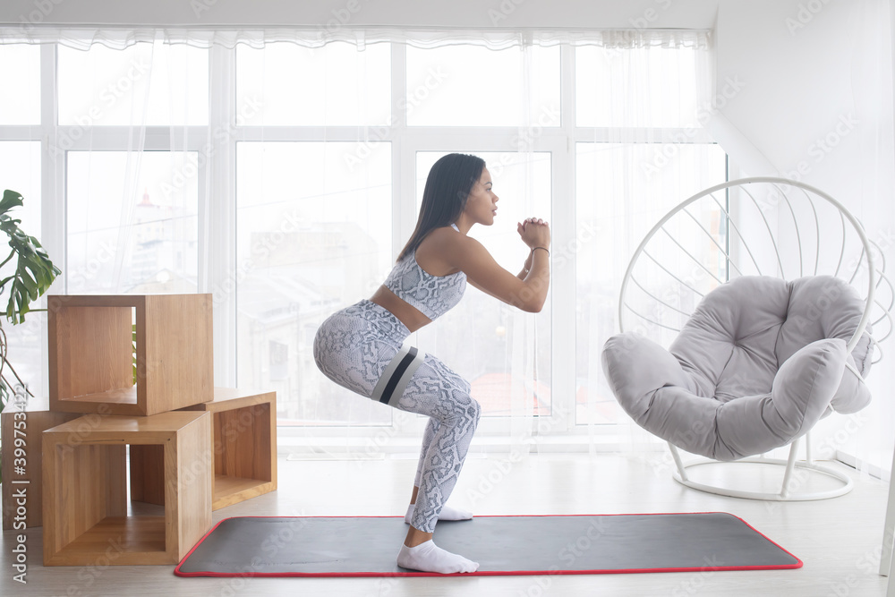 Sports during quarantine. Attractive black woman doing fitness on sports mat at home. Beautiful African American lady strengthening her body. Sports during quarantine. Attractive black woman doing fitness on sports mat at home. Beautiful African American lady strengthening her body.