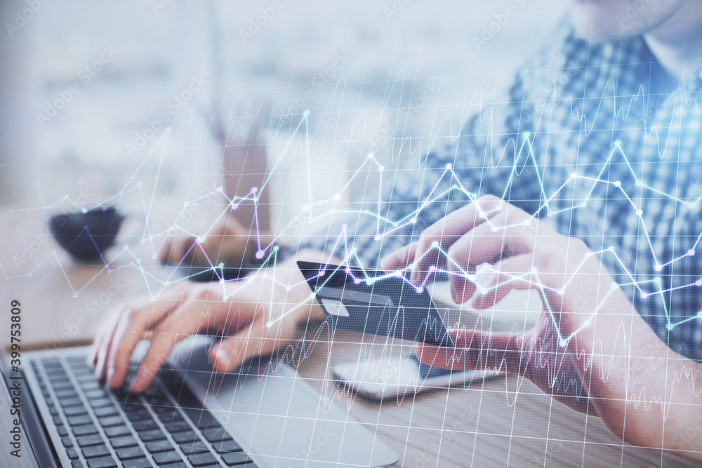 Double exposure of man hands holding a credit card and Forex graph drawing. Stock trading and digital fintech in Internet E-commerce concept. Double exposure of man hands holding a credit card and Forex graph drawing. Stock trading and digital fintech in Internet E-commerce concept.