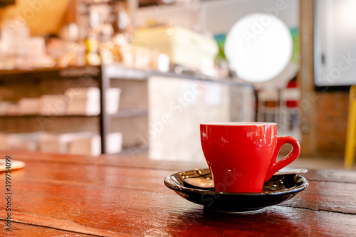 A hot americano is served at a coffee shop  putting on the wooden table.