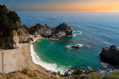 Scenic view of the famous McWay Falls on a beautiful sunny day with blue sky in summer, Julia Pfeiffer Burns State Park, Big Sur, California, USA photo