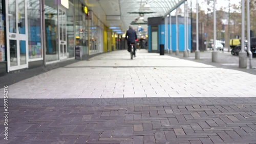Wallpaper Mural Shot of a old men cycling through empty Tilburg during covid-19 pandemic. Torontodigital.ca