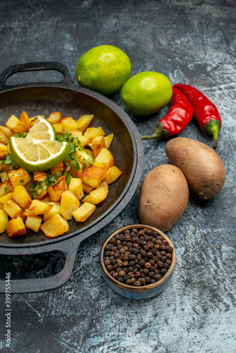 front view tasty fried potatoes with lemon and peppers on grey background food fry cooking color