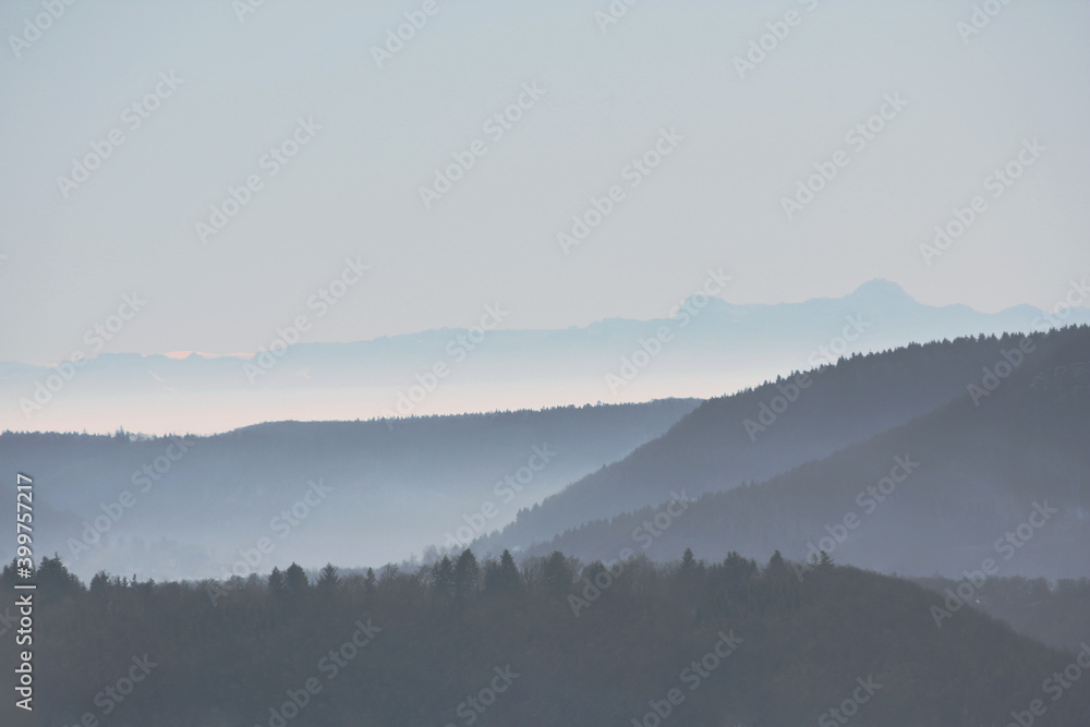 swabian alb in germany in fog with the alps in the back