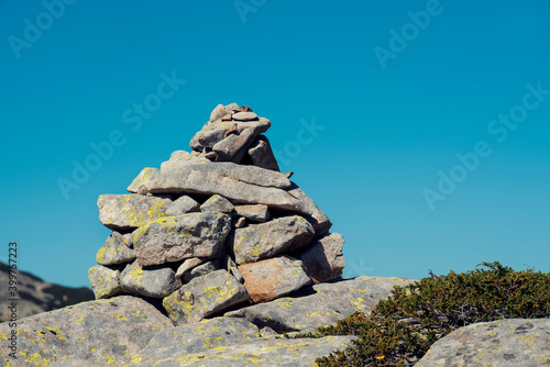 Pyramid of stones the mountain in Pirin National park in summer sunny day above the rock Blue sky and good weather © payamona