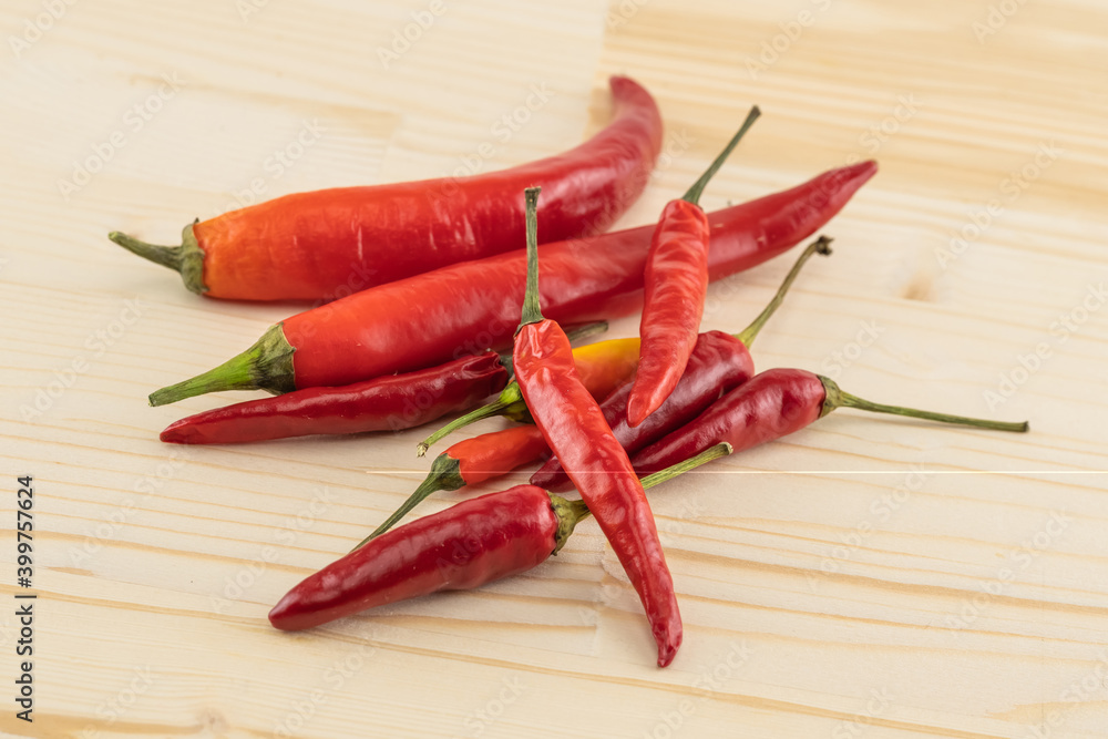 Ripe red chili peppers on wooden background sauce base