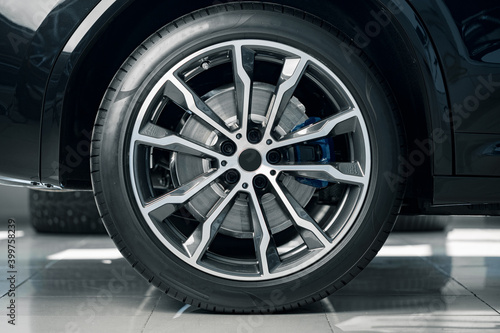 Aluminium rim of luxury car wheel close up © fotofabrika