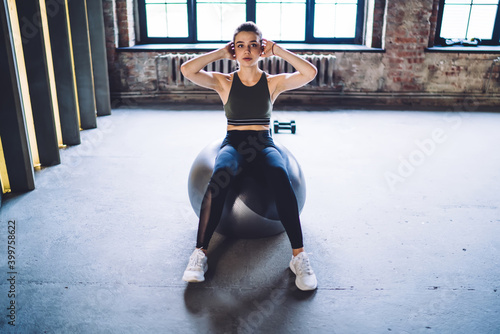 Fit woman doing sit ups on fit ball