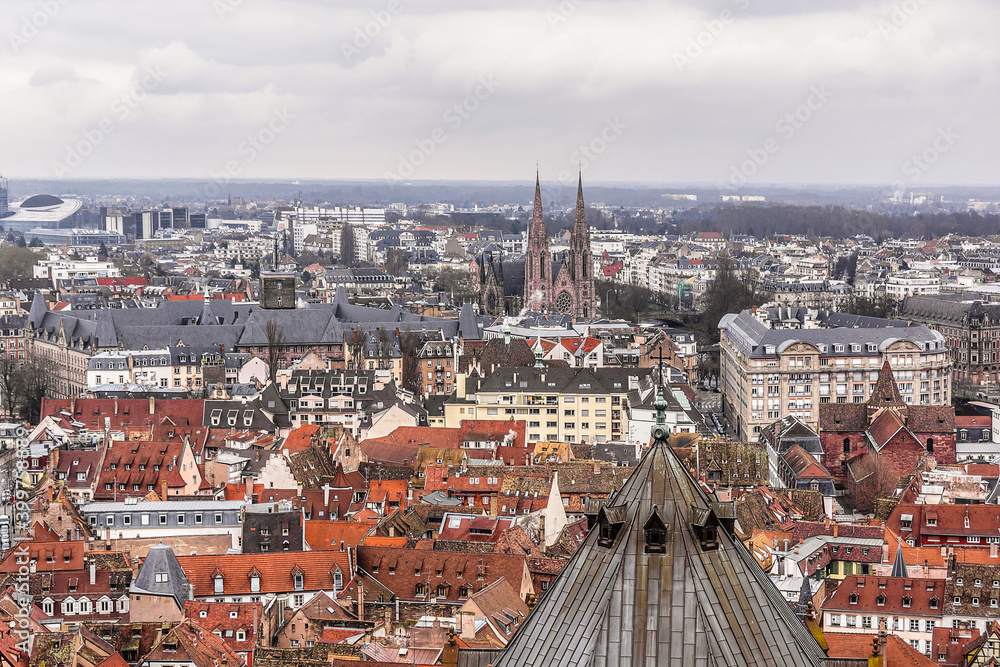 Fototapeta premium Aerial view of Strasbourg old city with red roof tiles. France. Strasbourg is the capital and principal city of Alsace region in eastern France and is official seat of European Parliament.