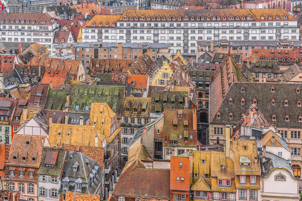 Fototapeta premium Aerial view of Strasbourg old city with red roof tiles. France. Strasbourg is the capital and principal city of Alsace region in eastern France and is official seat of European Parliament.