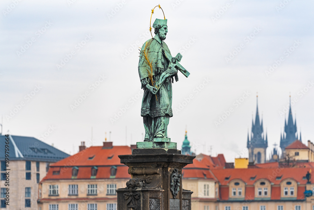 Prague, Czech Republic-February 02, 2019. Statue of saint John of Nepomuk the oldest on the north side of the famous Charles bridge, said to bring good luck to those who touch it.