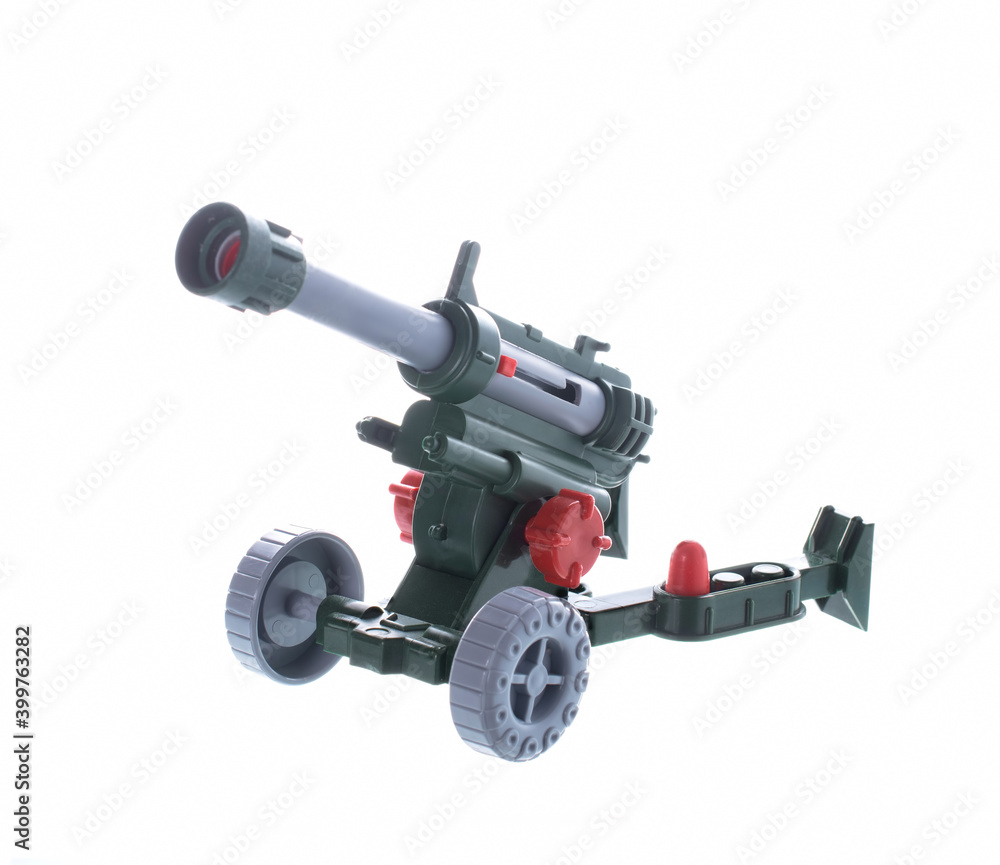 toy artillery cannon, fires plastic shells. isolated on white background.
