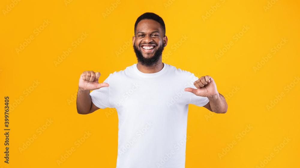 Happy African Man Pointing Thumbs At Himself Over Yellow Background Happy African Man Pointing Thumbs At Himself Over Yellow Background
