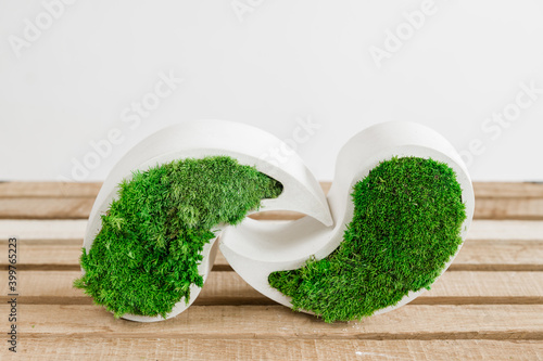 green grass in a heart shaped box. Icelandic green stabilized moss in concrete on a white background.