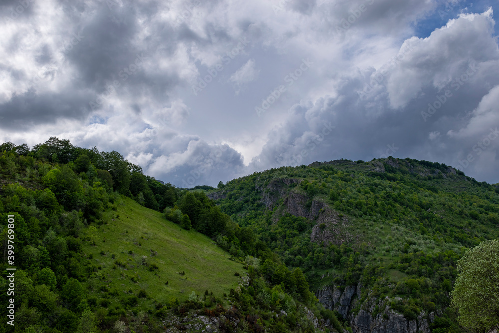 Mountain landscape against cloudy sky Mountain landscape against cloudy sky