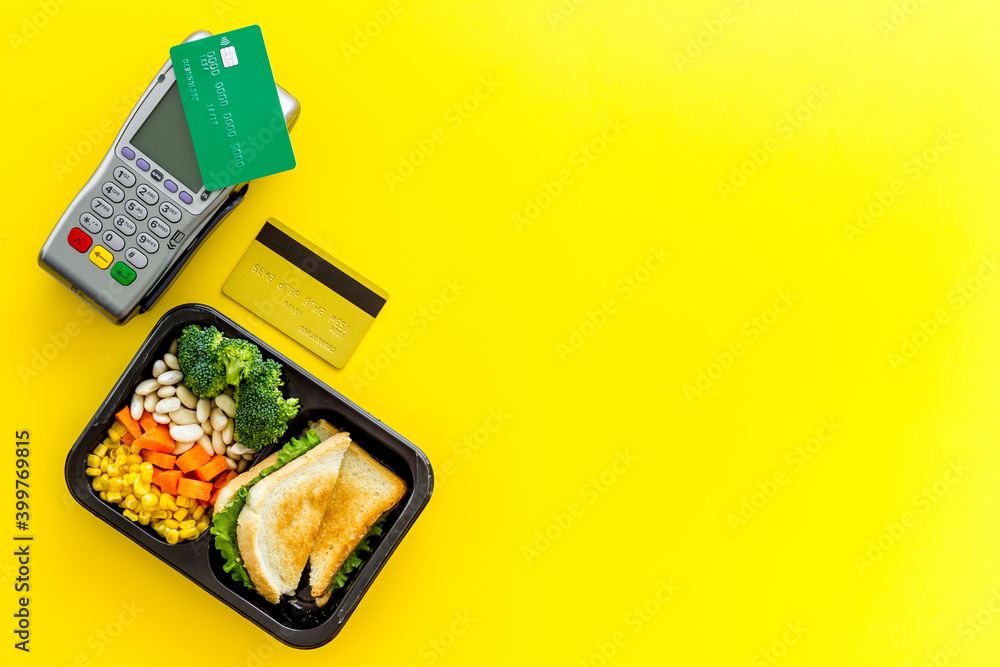 Food delivery payment with terminal and lunch boxes with meal Food delivery payment with terminal and lunch boxes with meal