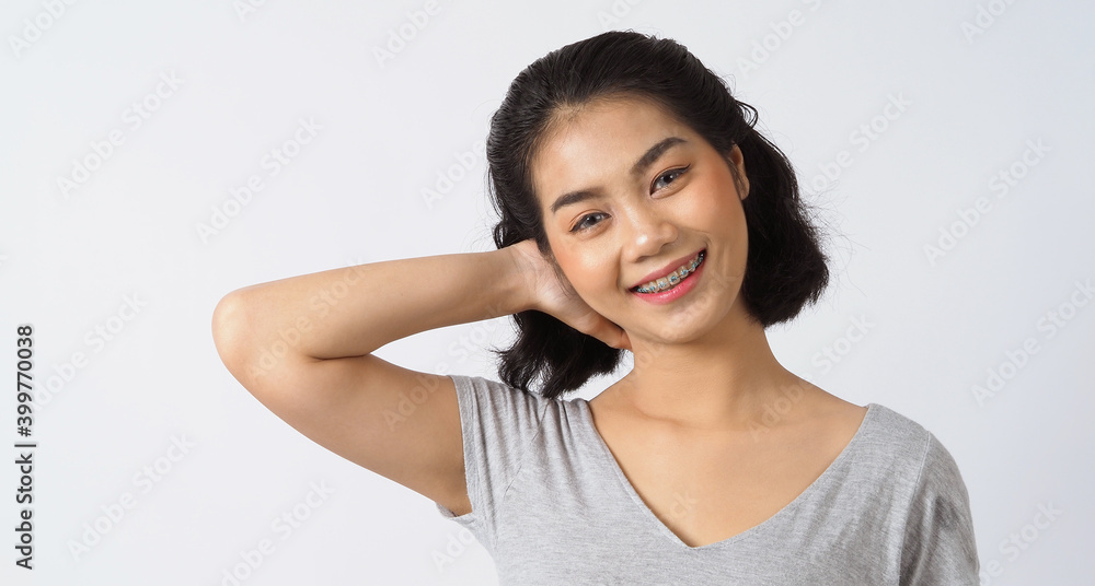 Dental brace teen girl smiling looking on a camera. white teeth with blue braces. Dental care. Asian woman smile with orthodontic accessories. Cosmetic dentistry, orthodontics treatment. studio shot. Dental brace teen girl smiling looking on a camera. white teeth with blue braces. Dental care. Asian woman smile with orthodontic accessories. Cosmetic dentistry, orthodontics treatment. studio shot.