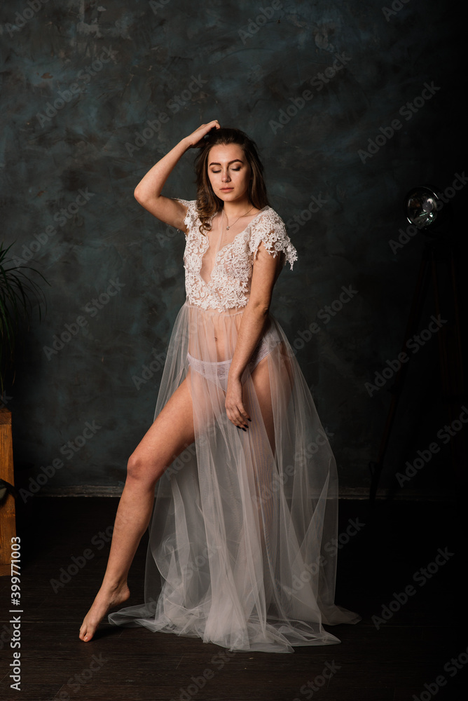 Beautiful bride in white lingerie sitting in her bedroom and studio. Beautiful bride in white lingerie sitting in her bedroom and studio.