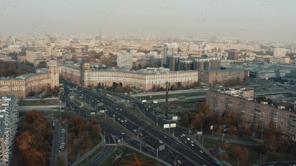 Drone pan shot of city from above, many residential buildings and multi-lane road with car traffic. Drone fly over left to right of urban cityscape in a big city under foggy sky Drone pan shot of city from above, many residential buildings and multi-lane road with car traffic. Drone fly over left to right of urban cityscape in a big city under foggy sky