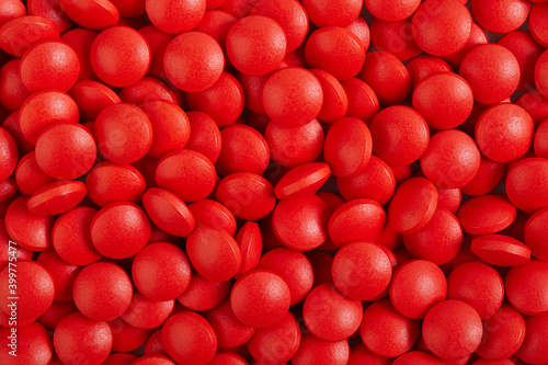 Background of red round tablets pills, macro close up