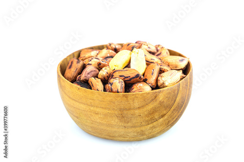 Roasted peanut in the wooden bowl isolated on white background.
