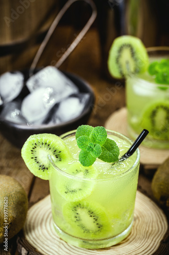 caipirinha, typical drink from Brazil based on fruit and cachaça, made with kiwi, sugar and brandy. Summer drink, served cold photo