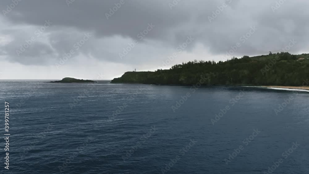 Aerial shot over the ocean near a tropical island in the rain (Kauai, Hawaii, USA)
Aerial shot over the ocean near a tropical island in the rain (Kauai, Hawaii, USA)