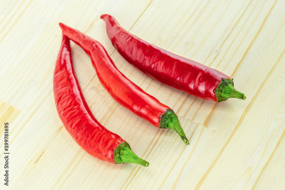 chili pepper hot pod fresh long vegetable lies parallel background