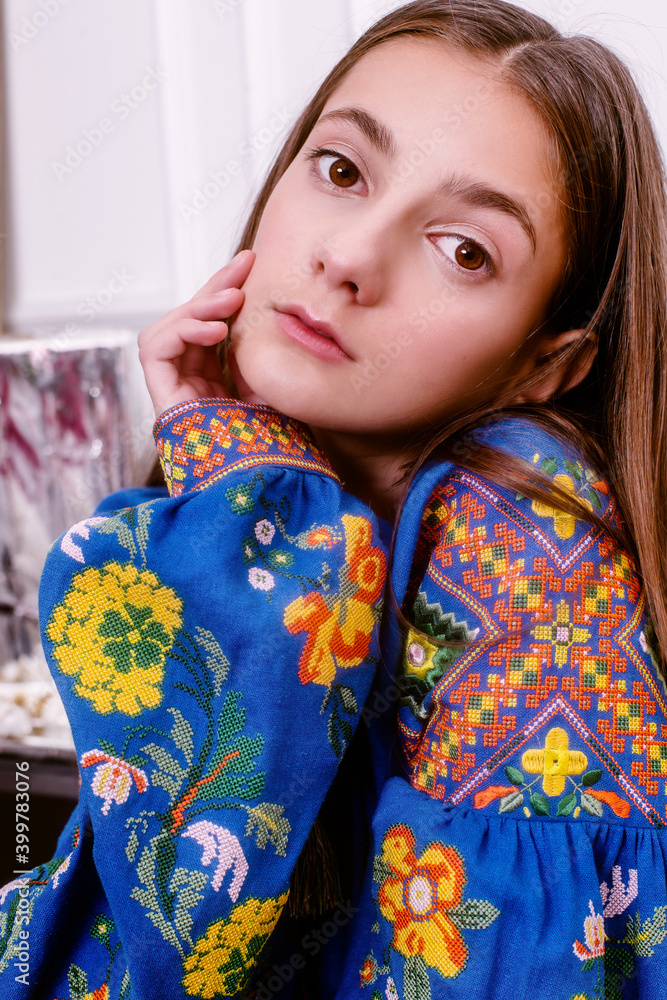 teenager in embroidered clothes surrounded by gifts.time for gifts teenager in embroidered clothes surrounded by gifts.time for gifts
