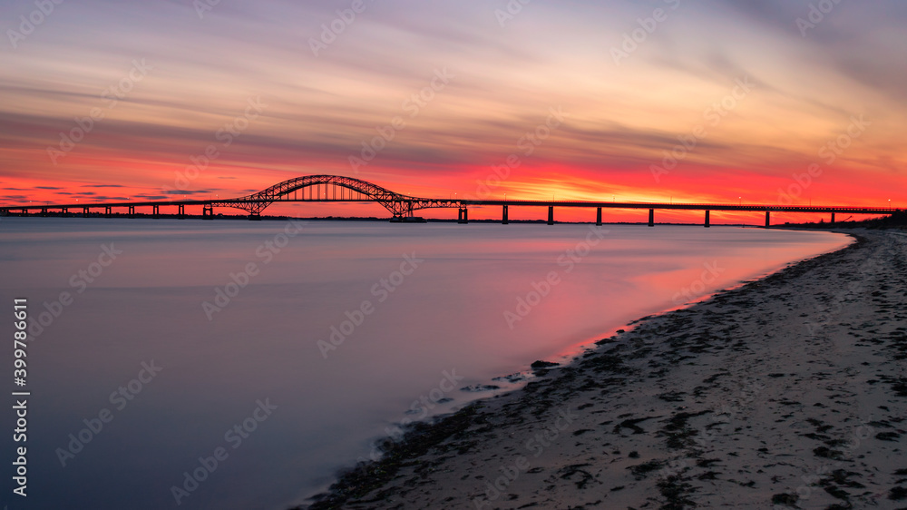 Smooth glassy water under steel tied arch bridge. Fire Island Inlet Bridge, Captree State Park New York Smooth glassy water under steel tied arch bridge. Fire Island Inlet Bridge, Captree State Park New York