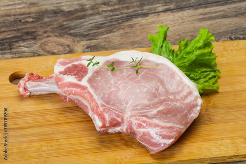 Raw pork bone steak over wooden
