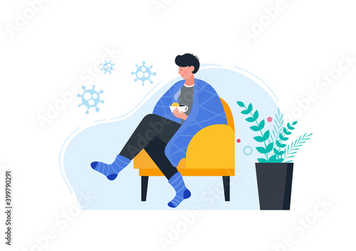Sick man in warm clothes drinking hot tea with lemon.