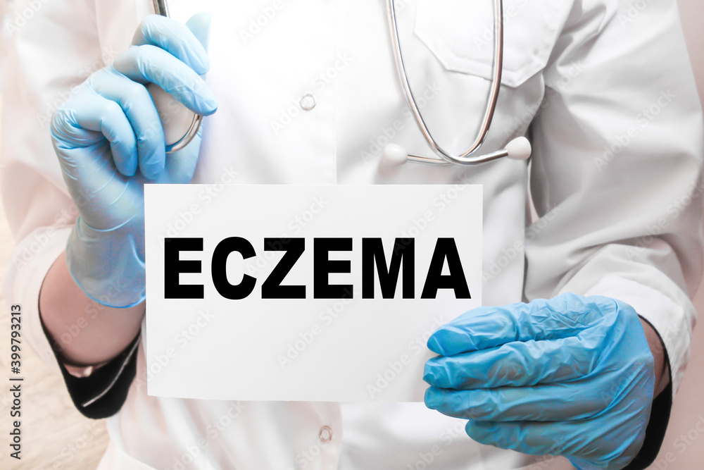 The doctor's blue - gloved hands show the word ECZEMA - . a gloved hand on a white background. Medical concept. the medicine The doctor's blue - gloved hands show the word ECZEMA - . a gloved hand on a white background. Medical concept. the medicine