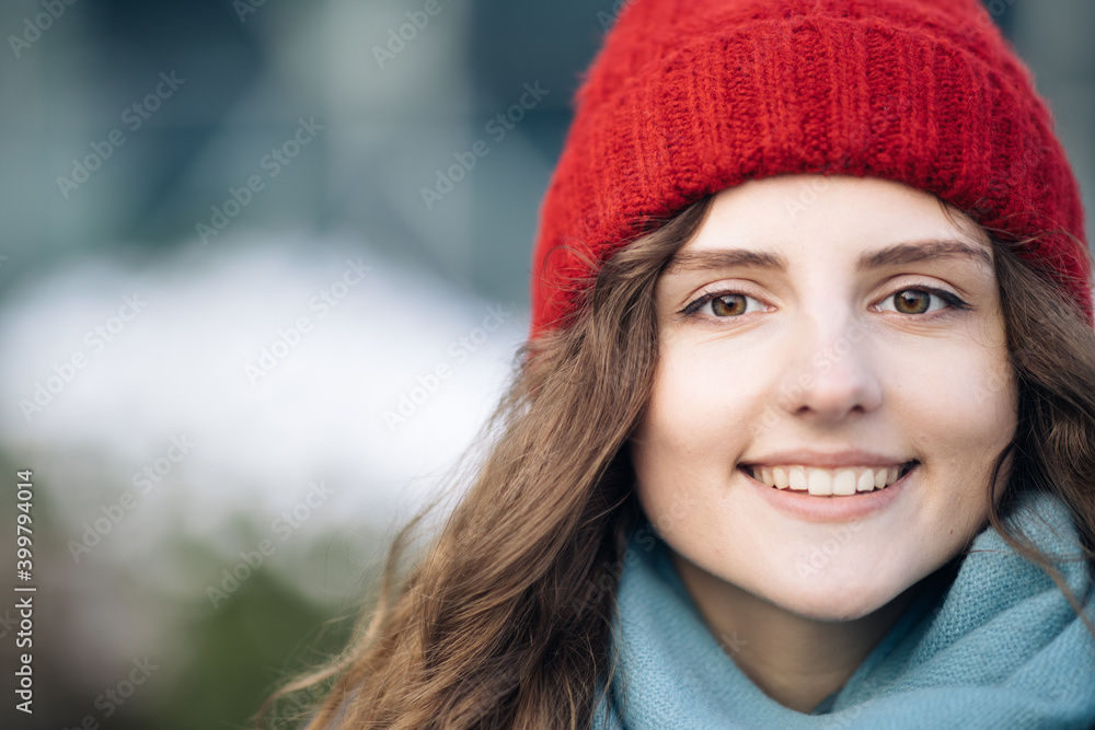CLose up Portrait young attractive curly haired smile woman with red hat look at camera at city center feel happy. Fshion girl. Stand on street CLose up Portrait young attractive curly haired smile woman with red hat look at camera at city center feel happy. Fshion girl. Stand on street