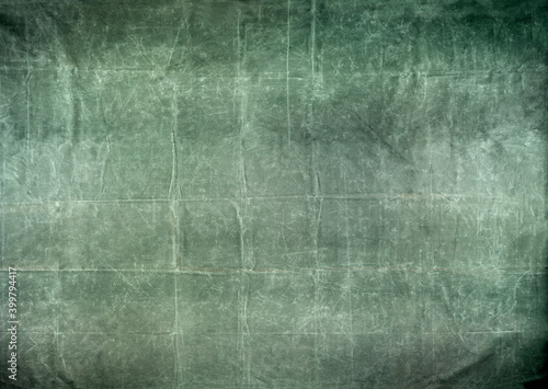 фотографія Worn and distressed army surplus green canvas tarp background