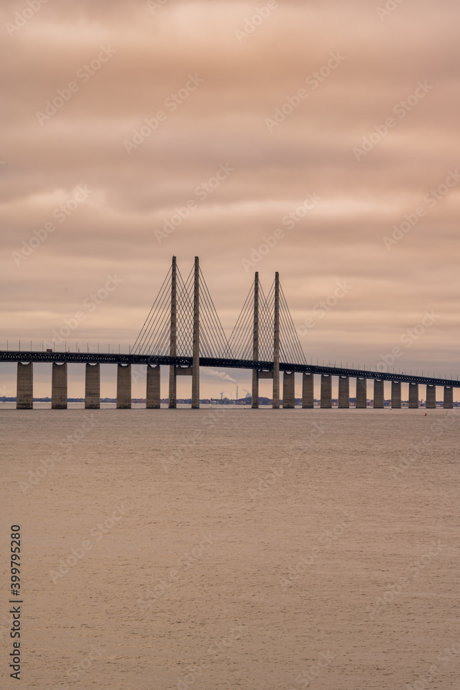 The Sound Bridge, the bridge and underwater tunnel connecting Malmo, Sweden with Copenhagen, Denmark. Beautiful sunset sky in the background The Sound Bridge, the bridge and underwater tunnel connecting Malmo, Sweden with Copenhagen, Denmark. Beautiful sunset sky in the background