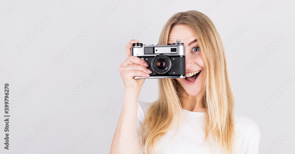 Happy smiling young girl holding camera and taking photos Happy smiling young girl holding camera and taking photos
