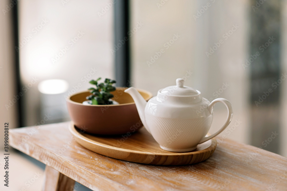 Kitchen utensils, such as kettle, coffee pot, on a wooden tray. Early breakfast. Soft selective focus. Kitchen utensils, such as kettle, coffee pot, on a wooden tray. Early breakfast. Soft selective focus.