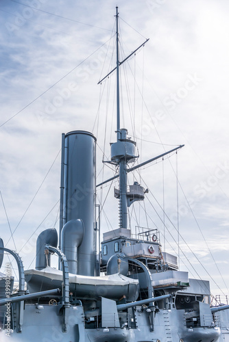 Cannons and mast on the battle cruiser "Aurora" built in the 19th century on the Neva river in St. Petersburg. The inscription on the lifebuoys: "Aurora"