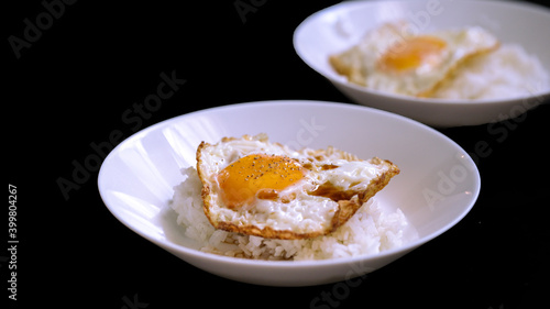 egg fried topping on rice isolated on black background