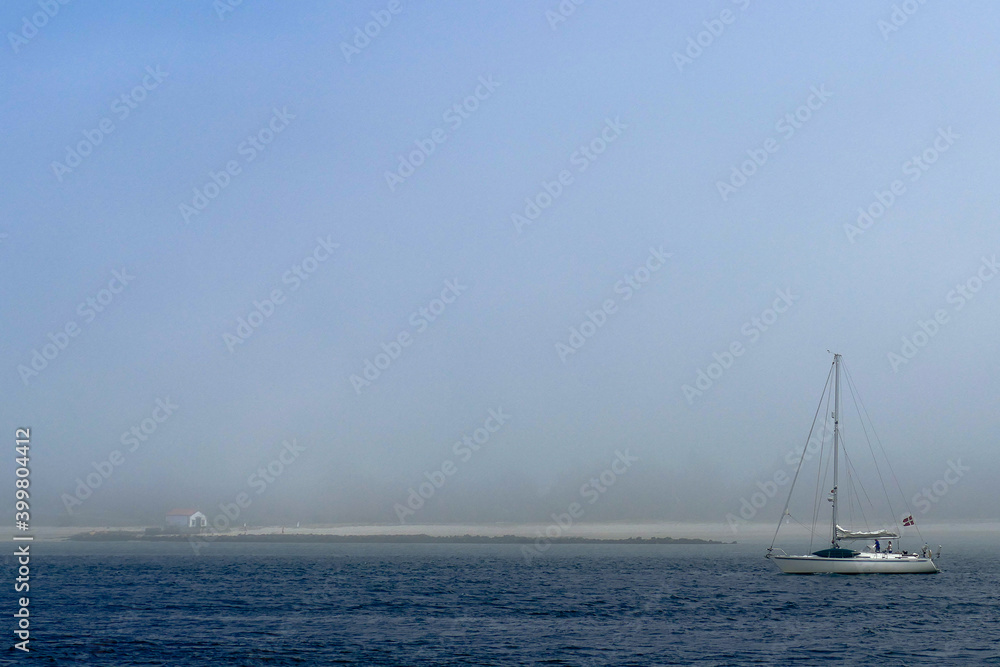 Portugal, Sailboat passing in front of an island on the Lima river in Viana do Castelo