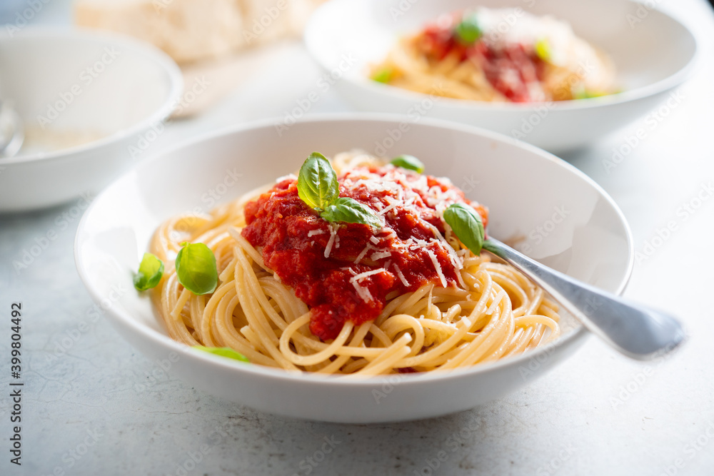 Spaghetti with tomato sauce and basil on a plate Spaghetti with tomato sauce and basil on a plate