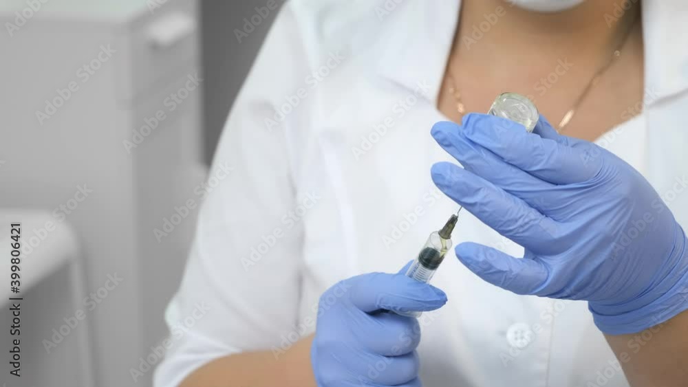 Beautician is preparing peeling preparation for face to patient. Doctor cosmetologist dials medicine with a syringe with a solution in beauty clinic, hands closeup. Beautician is preparing peeling preparation for face to patient. Doctor cosmetologist dials medicine with a syringe with a solution in beauty clinic, hands closeup.