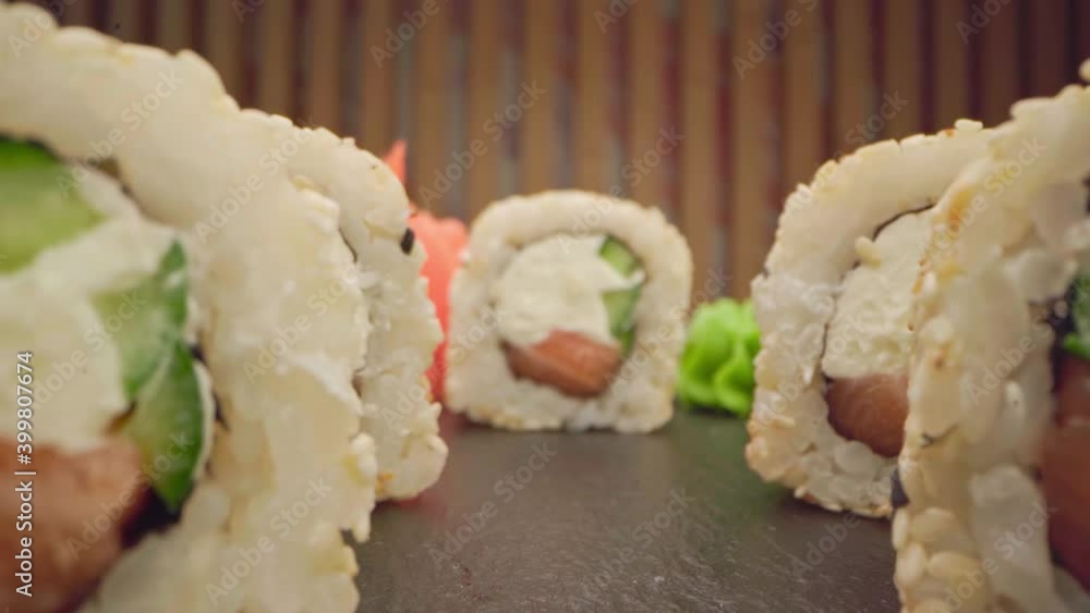 Zoom in slide video of japanese sushi roll on wooden background