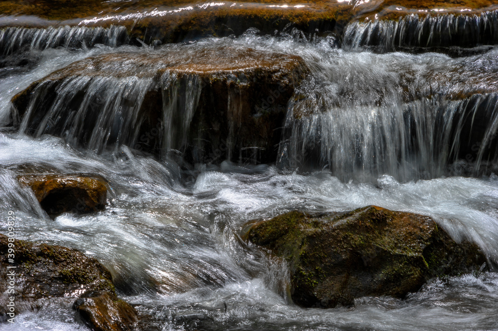 Close up of Creek water flowing over rocks Close up of Creek water flowing over rocks