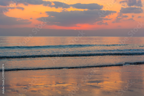 Amazing sunset over the ocean. Beautiful clouds and sun. Bright colors. 