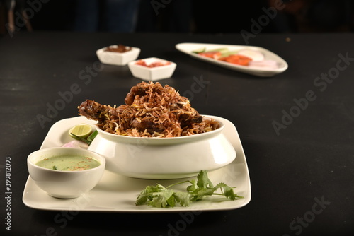 mutton biryani of bengal served with salad and raita photo