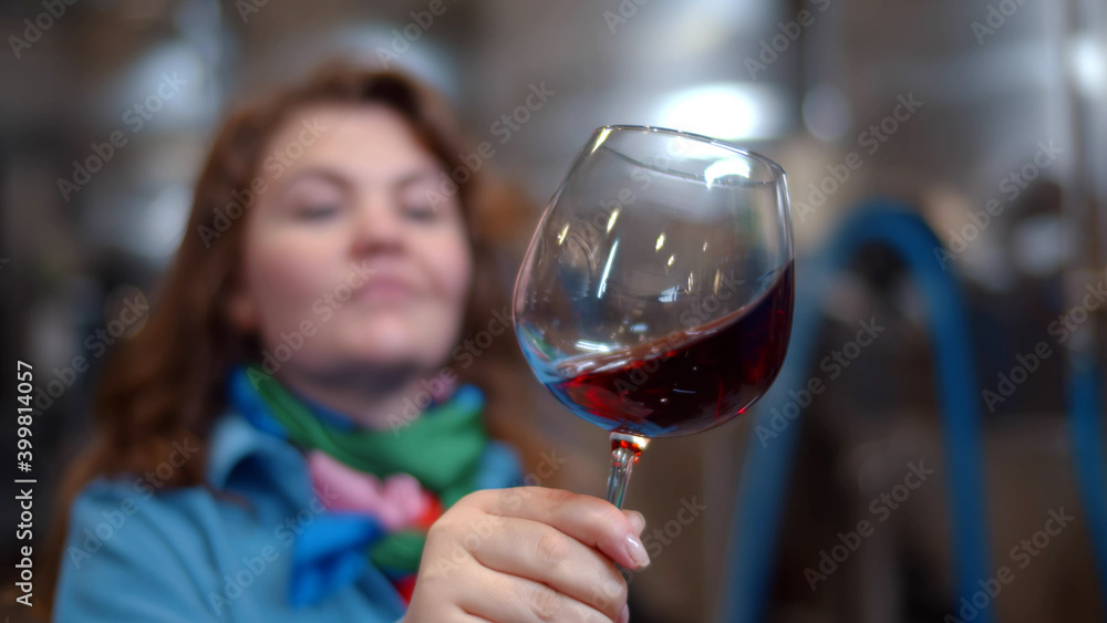 Young woman sommelier tasting in wine factory workshop Young woman sommelier tasting in wine factory workshop